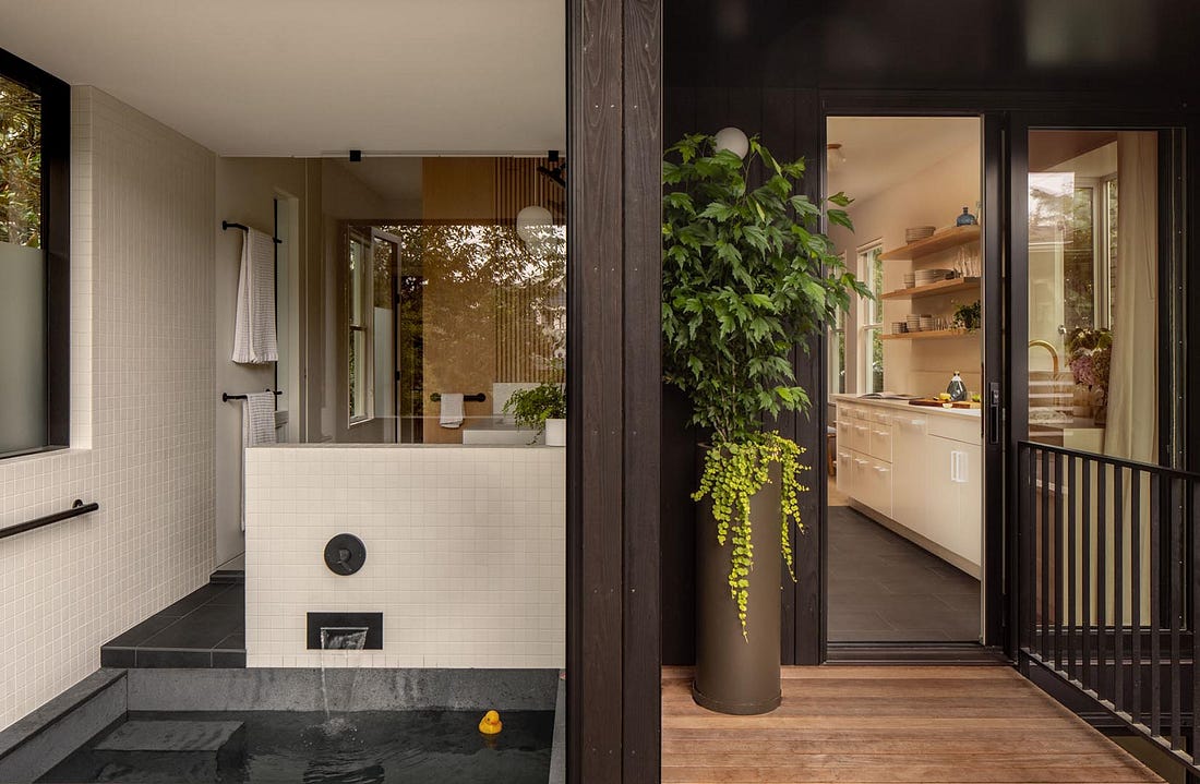 Sunken bathtub that opens from the indoors to outdoors