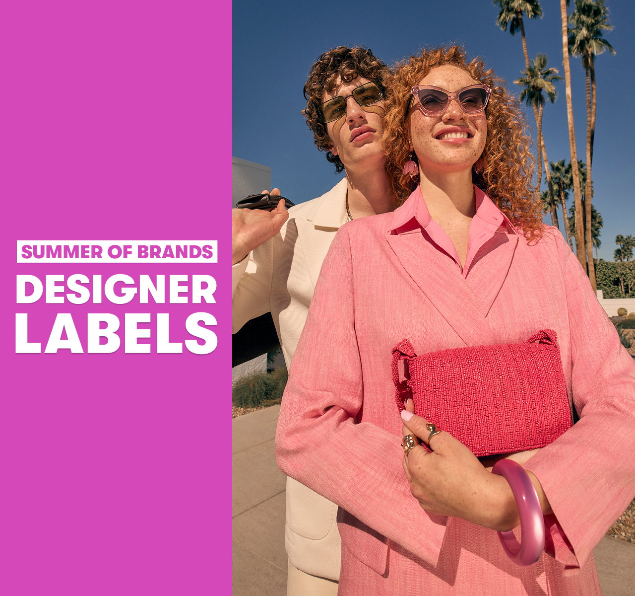 Two models in sunglasses stood outdoors with palm trees; one holds a pink clutch. Text reads “Summer of Brands. Designer Labels”.