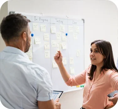 image-colleagues-discussing-notes-on-white-board