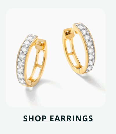 Pair of gold hoops with continuous front set of diamond stones engraved. Click here to shop earrings