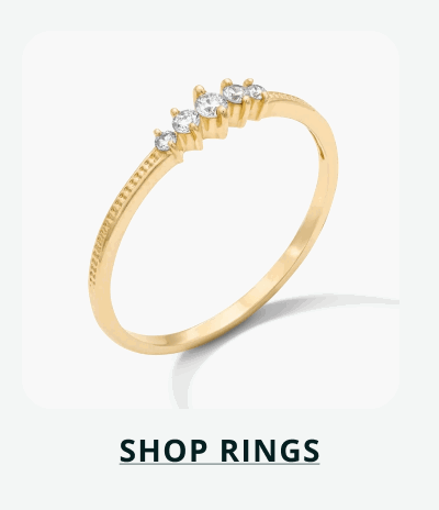 Gold ring with graduated row of four round stones set at top. Click here to shop rings