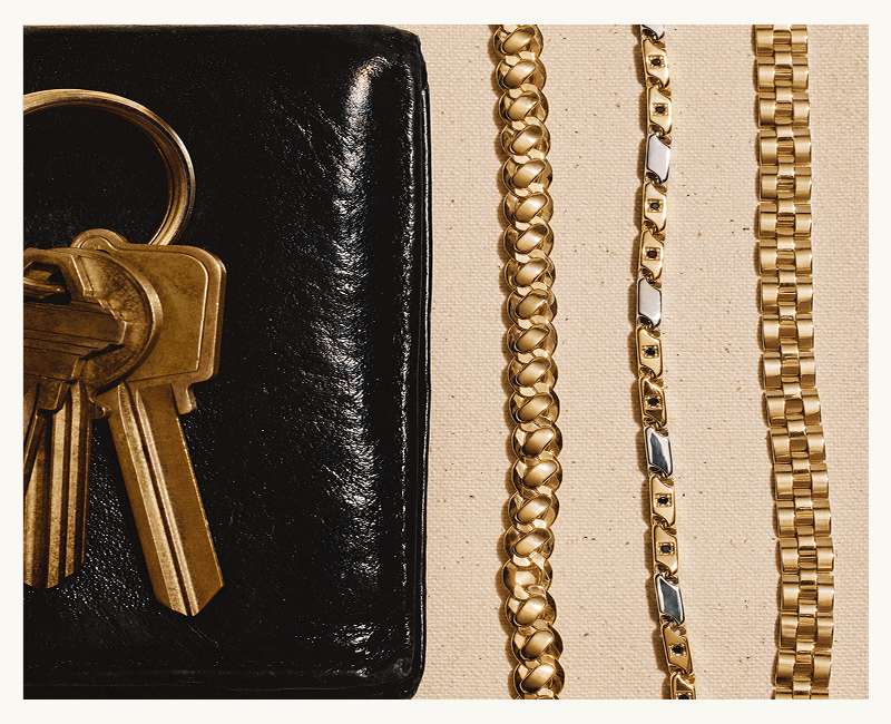 Black leather wallet with brass keys. Cuban, two-tone accented & watch-band chain.