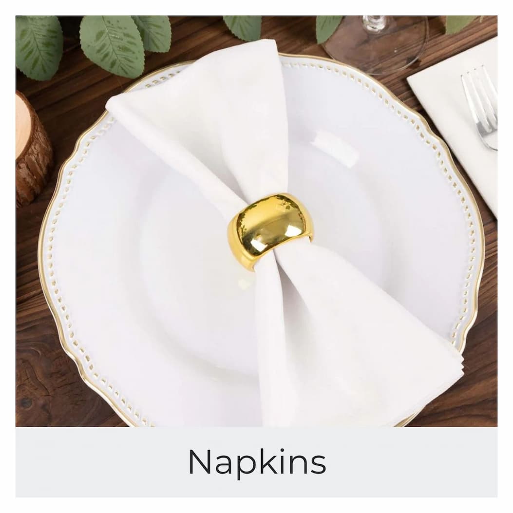 A lavender napkin is folded and held by a gold napkin ring on a white plate.