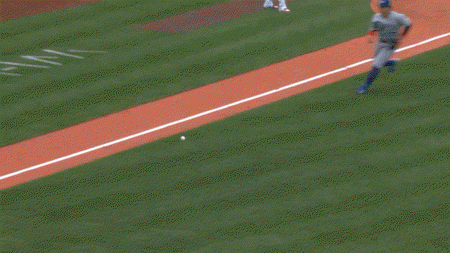An animated GIF of Kazuma Okamoto making a barehanded throw to first