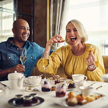 A couple enjoying Champagne Afternoon Tea
