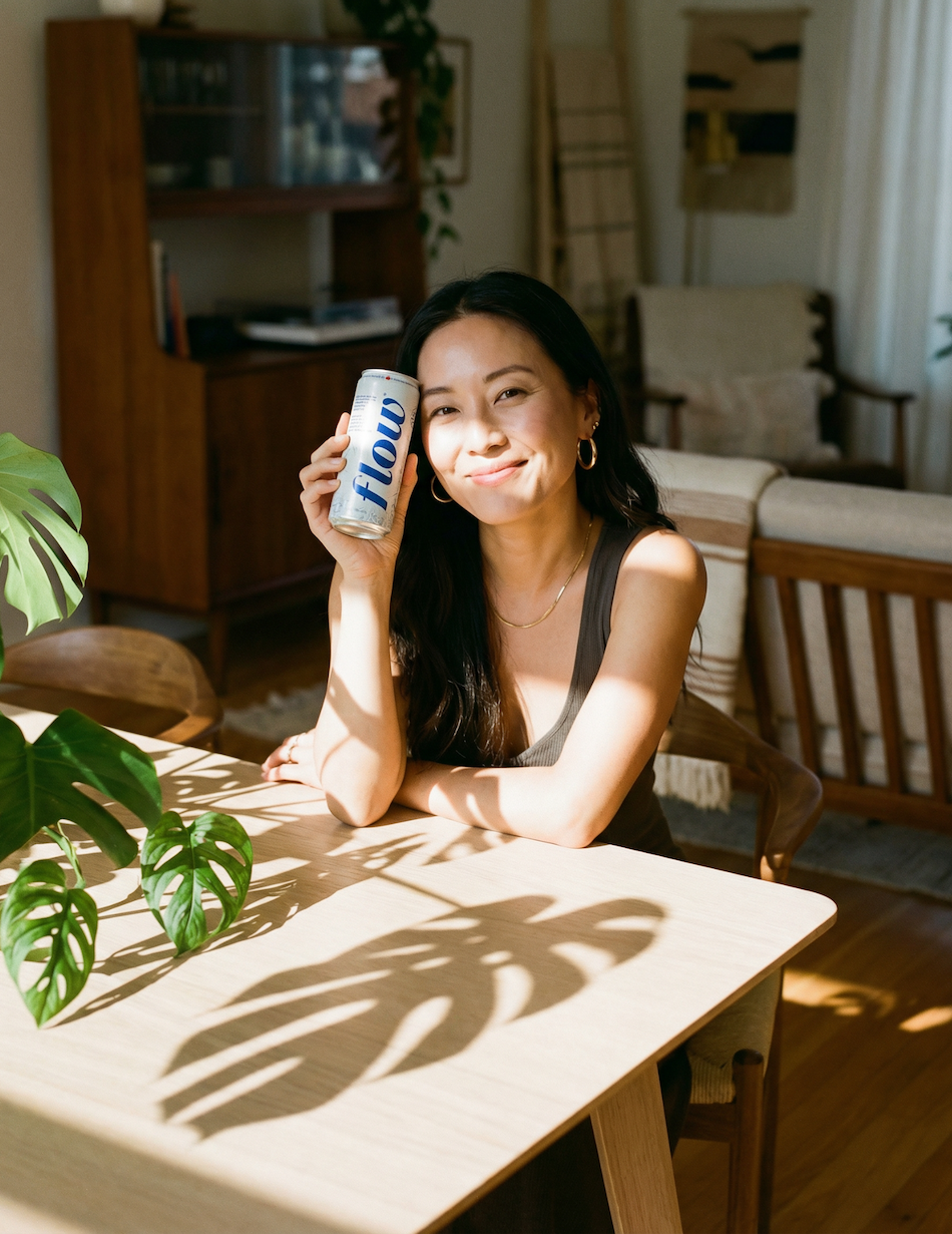 Woman holding bottle of Flow water