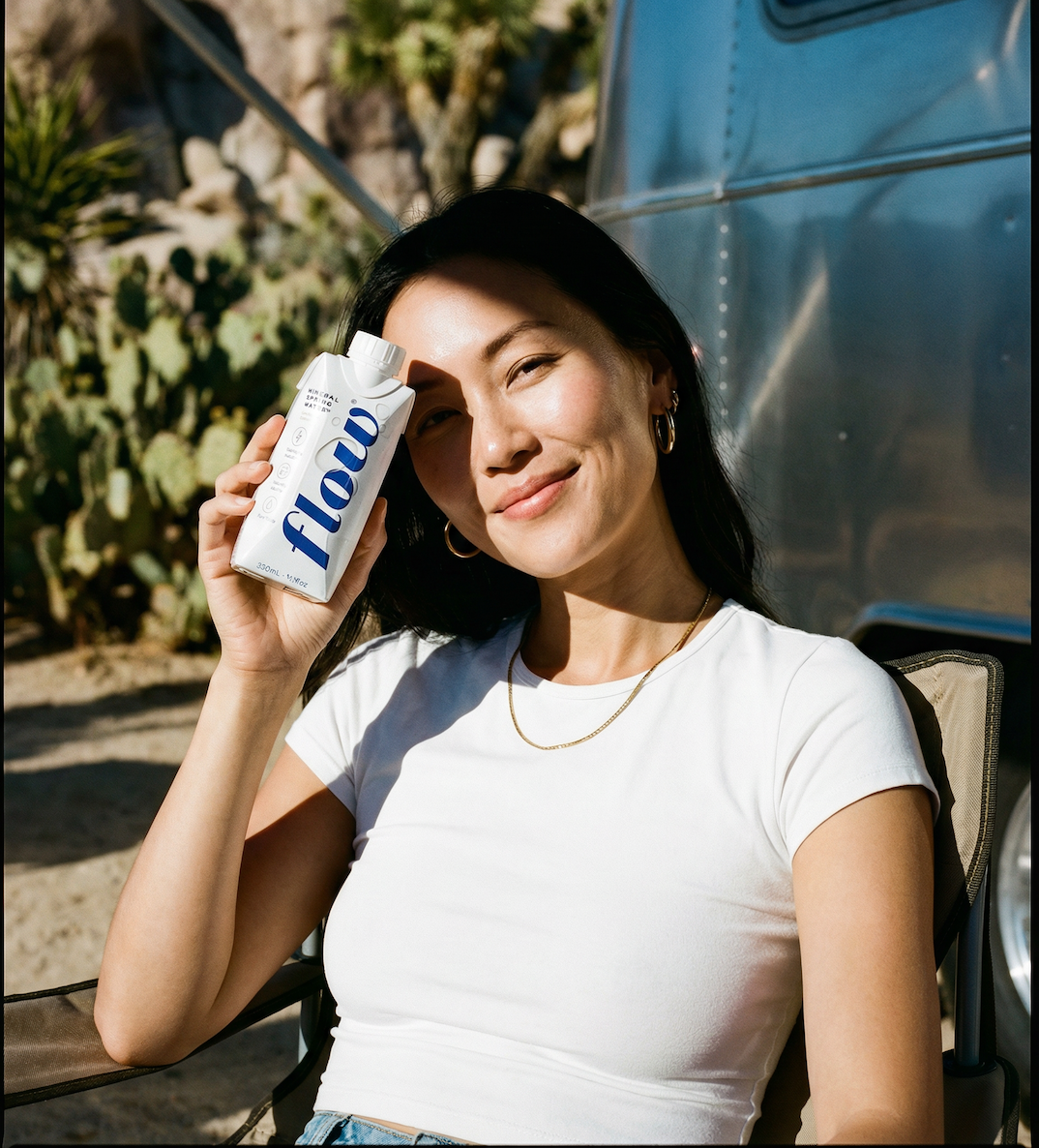 Woman holding bottle of Flow water