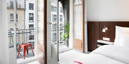 A guest room balcony overlooks Geneva at Ruby Claire Hotel.