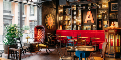 The eclectic lobby at Ruby Molly includes bright red banquette seating and plenty of tables to mix and mingle.