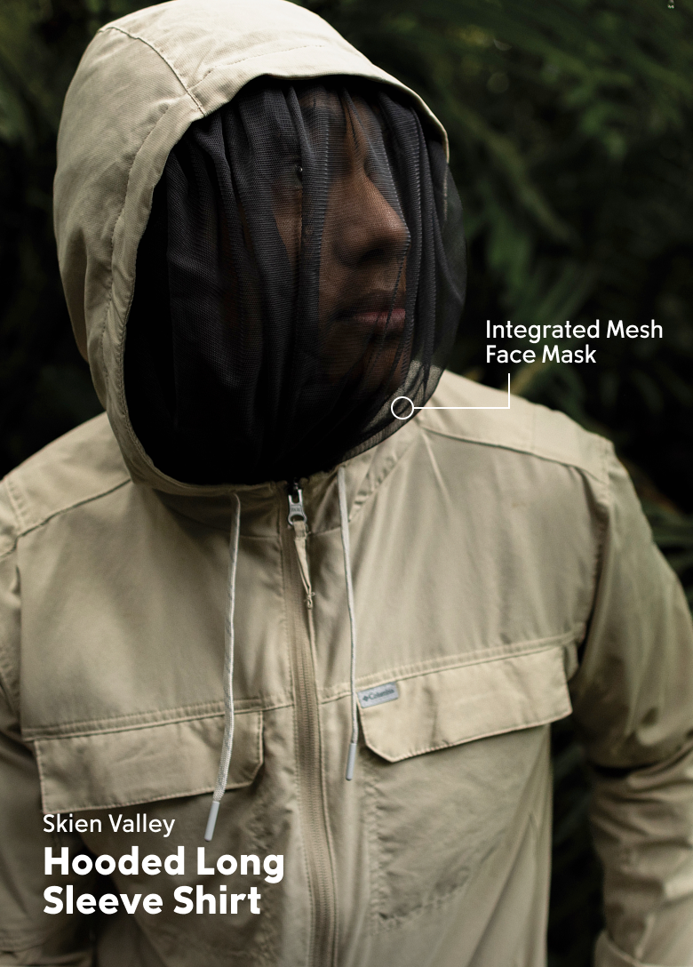 A man wearing a tan long sleeve shirt with the hood up and face mask covering with text: Skein Valley Hooded Long Sleeve Shirt