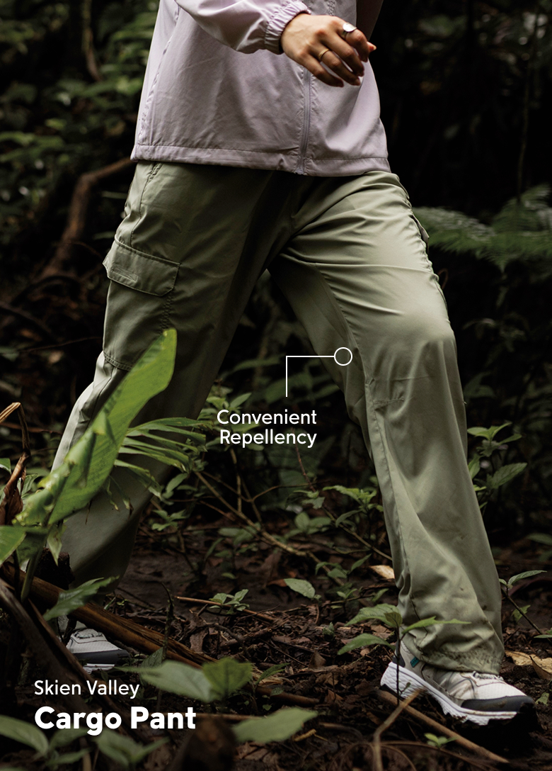 Waist-down image of a woman walking in green pants with text: Skien Valley Cargo Pant. Convenient Repellency.