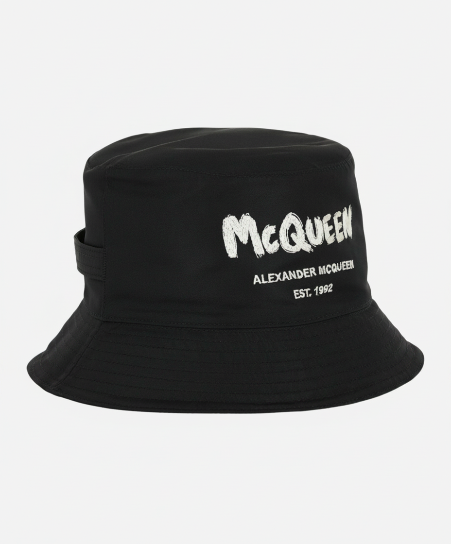 Black bucket hat with white "McQUEEN ALEXANDER MCQUEEN EST. 1992" logo.