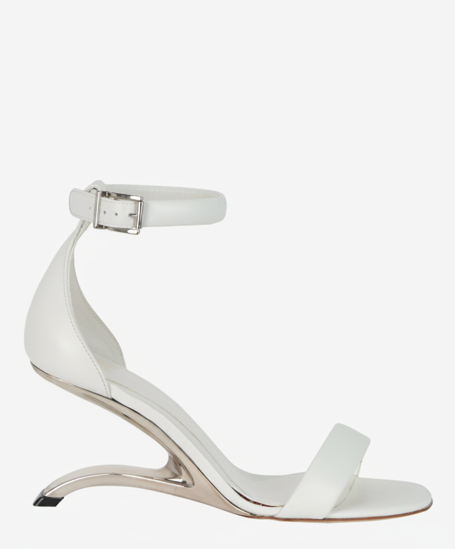 White leather sandal with a metallic sculptural heel and ankle strap.