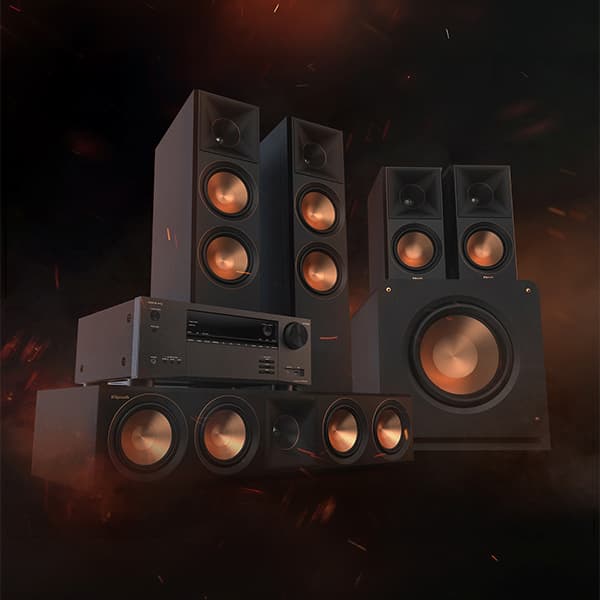 Klipsch home theater system on a dark and smokey background, with sparks flying