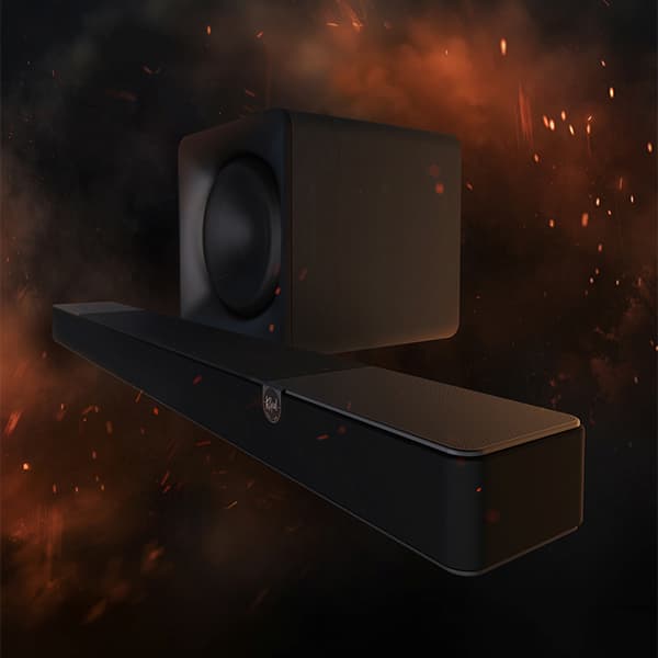 Klipsch Flexus sound bar and subwoofer on a dark and smokey background, with sparks flying