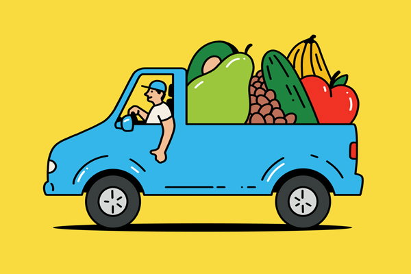 Truck full of oversized fruits and vegetables.