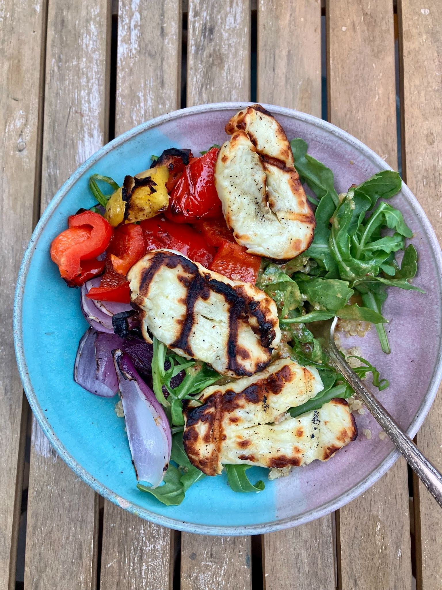 tofu on a white plate with a bowl of sauce on the left side
