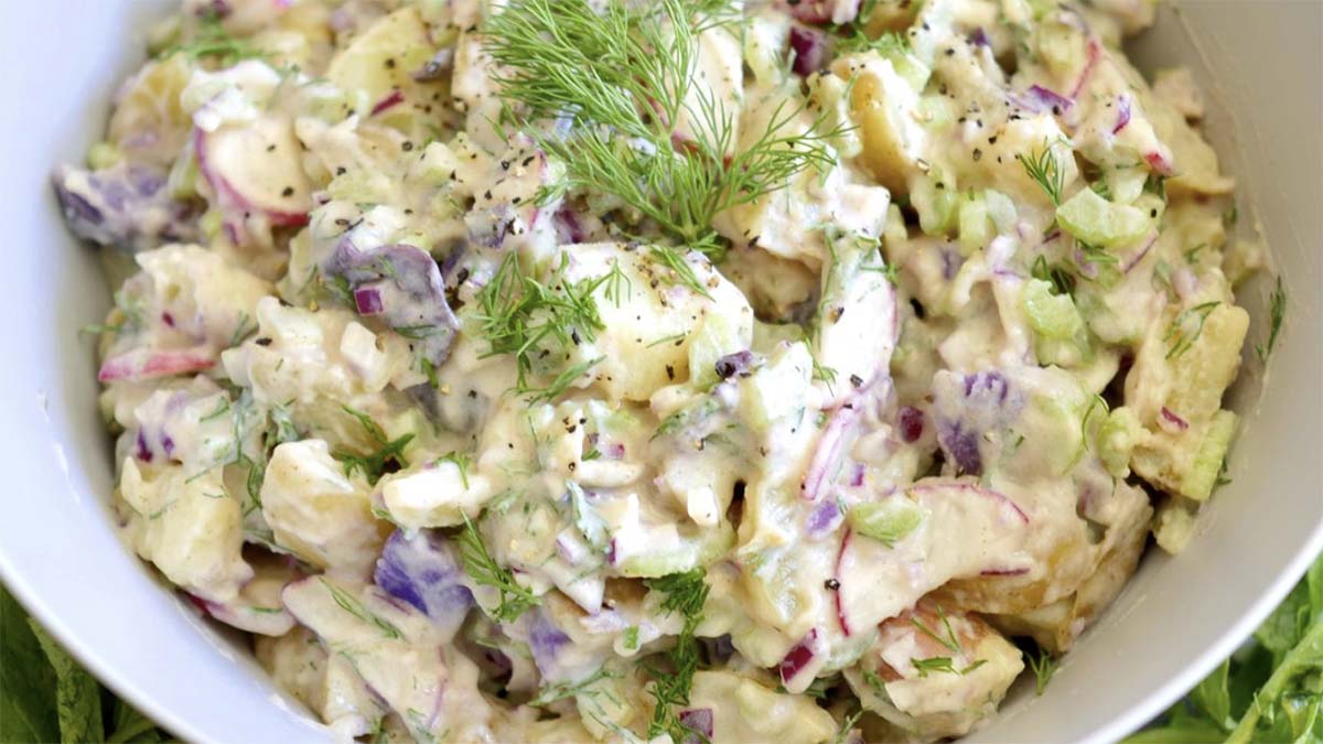 a white bowl filled with potato salad