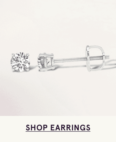 Pair of round-cut diamond studs set in four-prong white metal setting. Click here to shop earrings