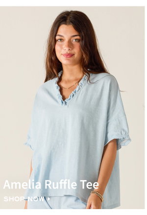 Amelia Ruffle Tee - Shop now - Image of a woman wearing a light blue short sleeve tee with ruffle details.
