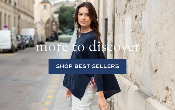 More to discover - Shop best sellers - Image of a woman wearing a navy sweater with side slits.