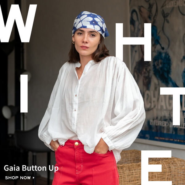 Gaia Button Up - Shop now - Image of a woman wearing a white flowy button-up shirt.