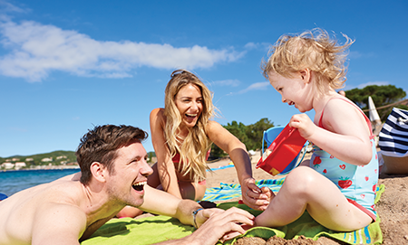 Toddler and parents on the beach