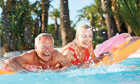 Adults on a pool float splashing