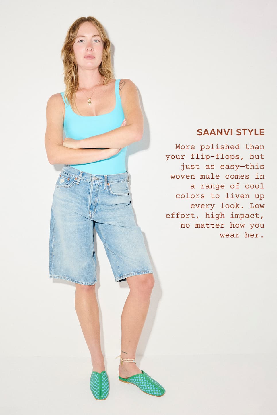 woman in clue top, jen shorts, and green and blue woven slides