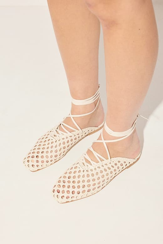 women wearing vanilla colored woven mules with ankle laces 