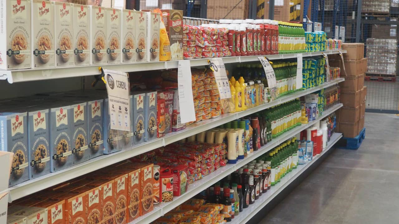 A grocery store aisle in a large warehouse