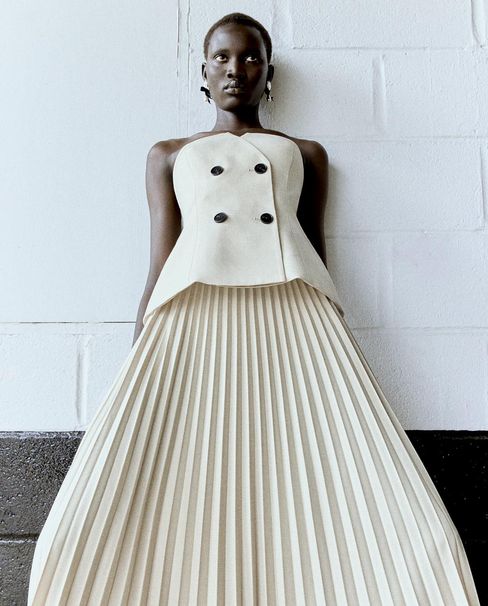 A picture of a woman in the Beige Bandeau Pleated Midi Dress