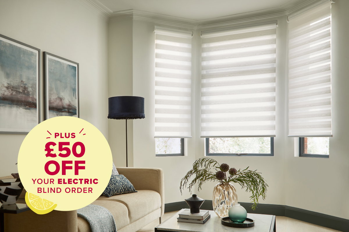 Three white electric roller blinds installed in a curved bay window of a modern living room