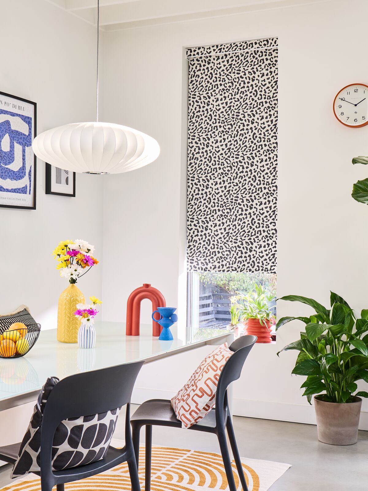  Modern dining room featuring a black and white patterned roller blind