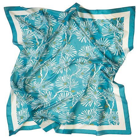 Teal and ivory silk scarf featuring a traditional Japanese pine needle design. - Shop Now.
