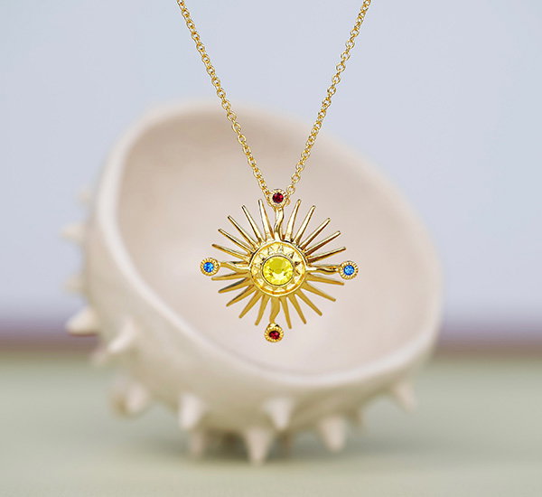Necklace inspired by a detail from the Holy Thorn Reliquary displayed against a sculptural ceramic backdrop in soft pastel tones. - Jewellery Collection.