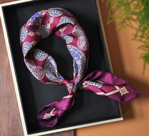 A silk scarf with an Anglo-Saxon inspired knot design tied in a display box. - Scarves Collection.