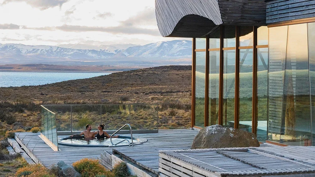 Image description: Couple in the hot tub at Tierra Patagonia in Torres del Paine National Park, Chile.
