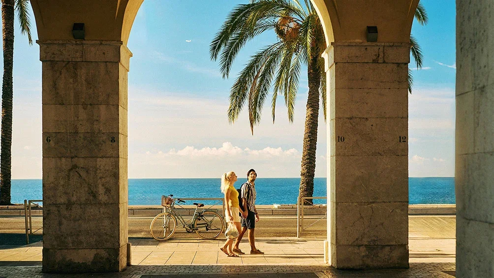 Image description: A couple walks along the Promenade des Anglais in Nice, France
