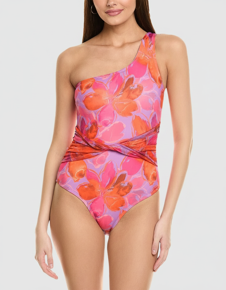 A woman in a one-shoulder swimsuit with a vibrant floral print.