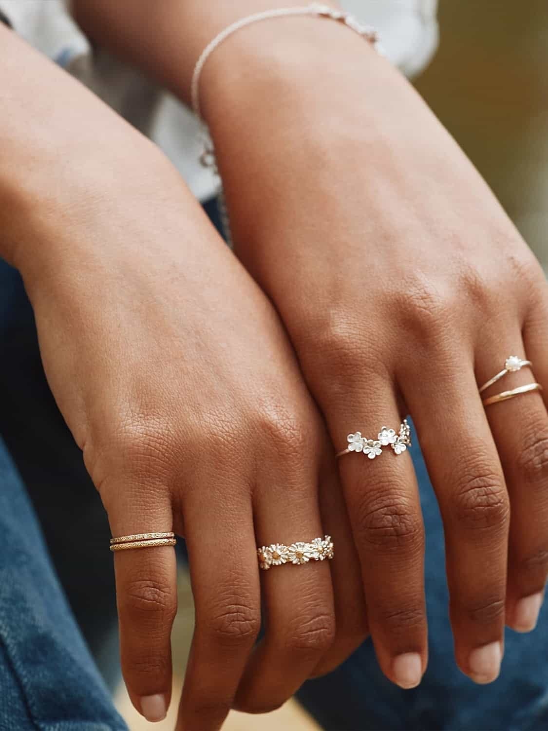 Model hands wearing Alex Monroe stacking rings.