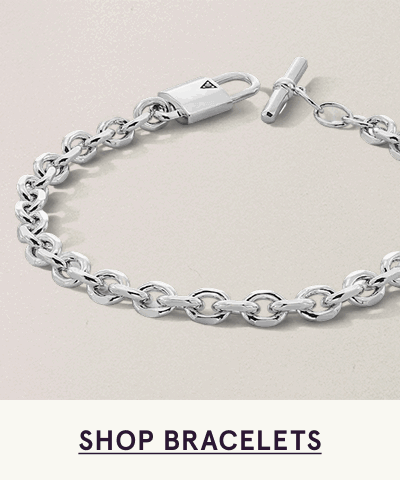Silver cable-link chain bracelet with padlock charm & toggle clasp closure. Click here to shop bracelets