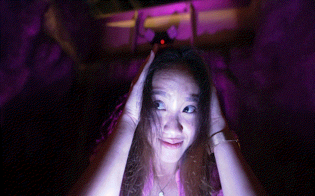 A young woman screaming inside a haunted house during Howl-O-Scream at Busch Gardens