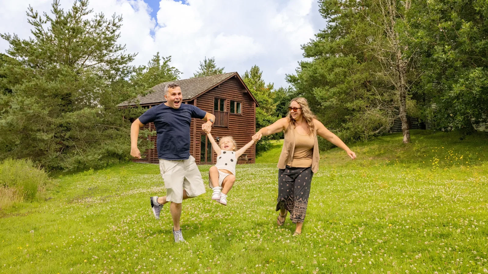 Family running through a Bluestone field outside a lodge