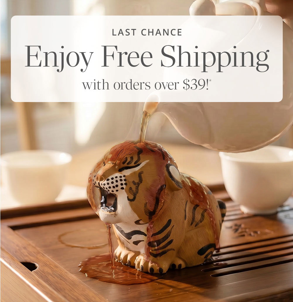 Tiger tea pet on wood tray with person pouring hot water from a white Chatsford teapot