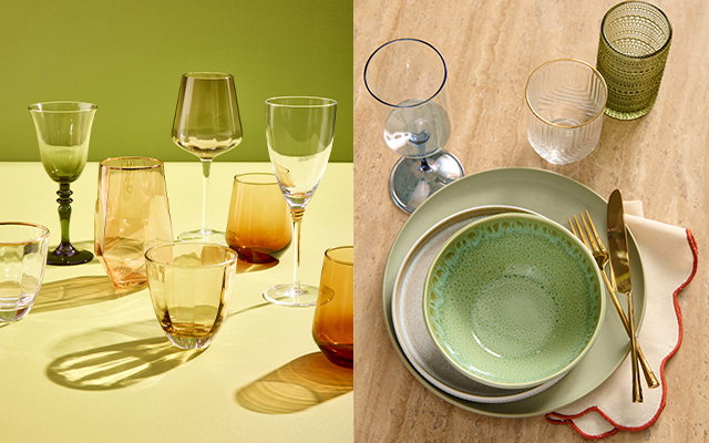 Glassware arranged on a table beside a place setting with plates, bowl, cutlery and glasses.