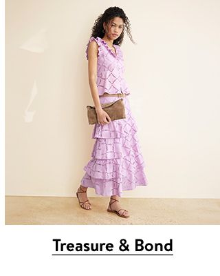 A woman wearing a matching top-and-skirt set from Treasure & Bond.