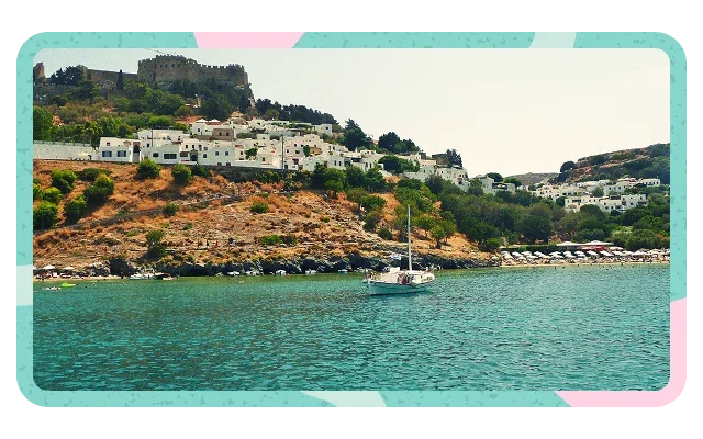Turquoise border, pink geometric shapes at corners, turquoise-green sea water, small white boat, white-washed hillside buildings, stone fortress with cylindrical tower, vegetation, pale cream sky, rounded corners and Greek island architecture.