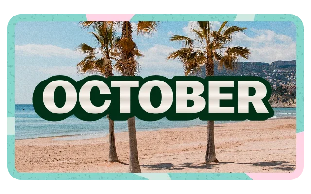 Light blue sky, white clouds, three palm trees, thick brown trunks, green fronds, beige-tan sandy beach, calm turquoise-blue ocean, distant hillside buildings, turquoise border, pink accent, 'OCTOBER' dark green text and white outline.