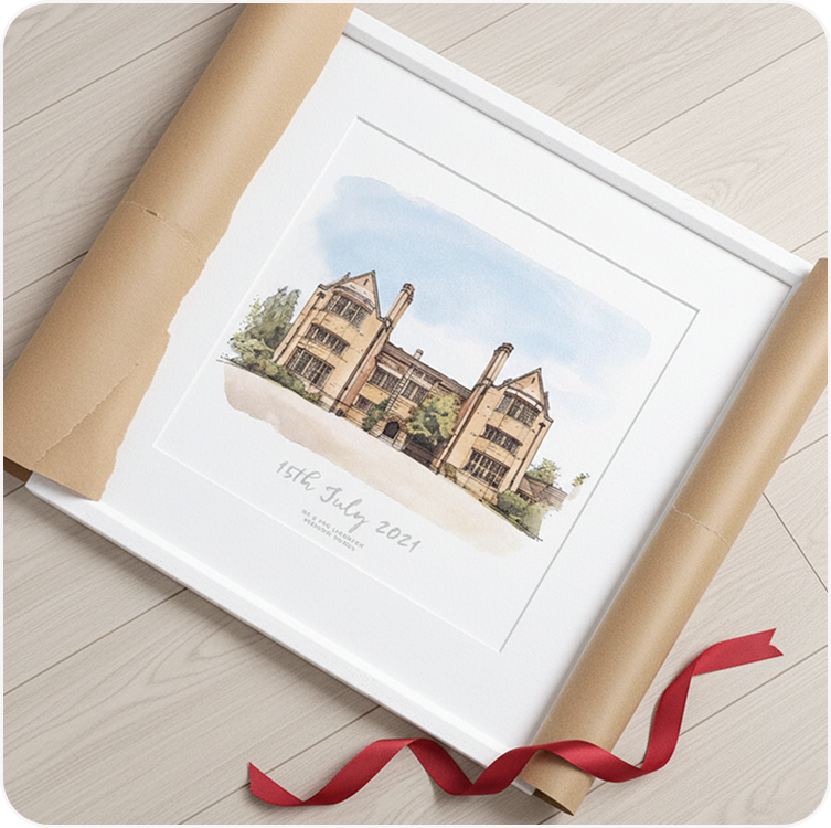 A framed watercolour illustration of a wedding venue, tied with a red ribbon and resting on brown wrapping paper